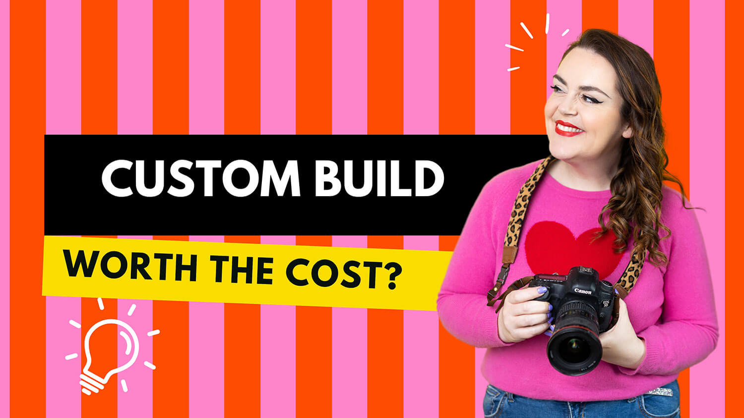 Rosie Parsons, a professional photographer, smiles warmly while holding a Canon DSLR camera with a leopard print strap. She wears a bright pink jumper with a red heart design, has dark wavy hair, red lipstick, and lilac nail polish. The bold graphic background features pink and orange stripes with text reading "Custom Build" in white on a black box and "Worth the Cost?" in black on a yellow banner. A lightbulb icon adds a creative touch. The image introduces a guide on custom course design versus using webdesign inspiration from ready-made online course platforms.