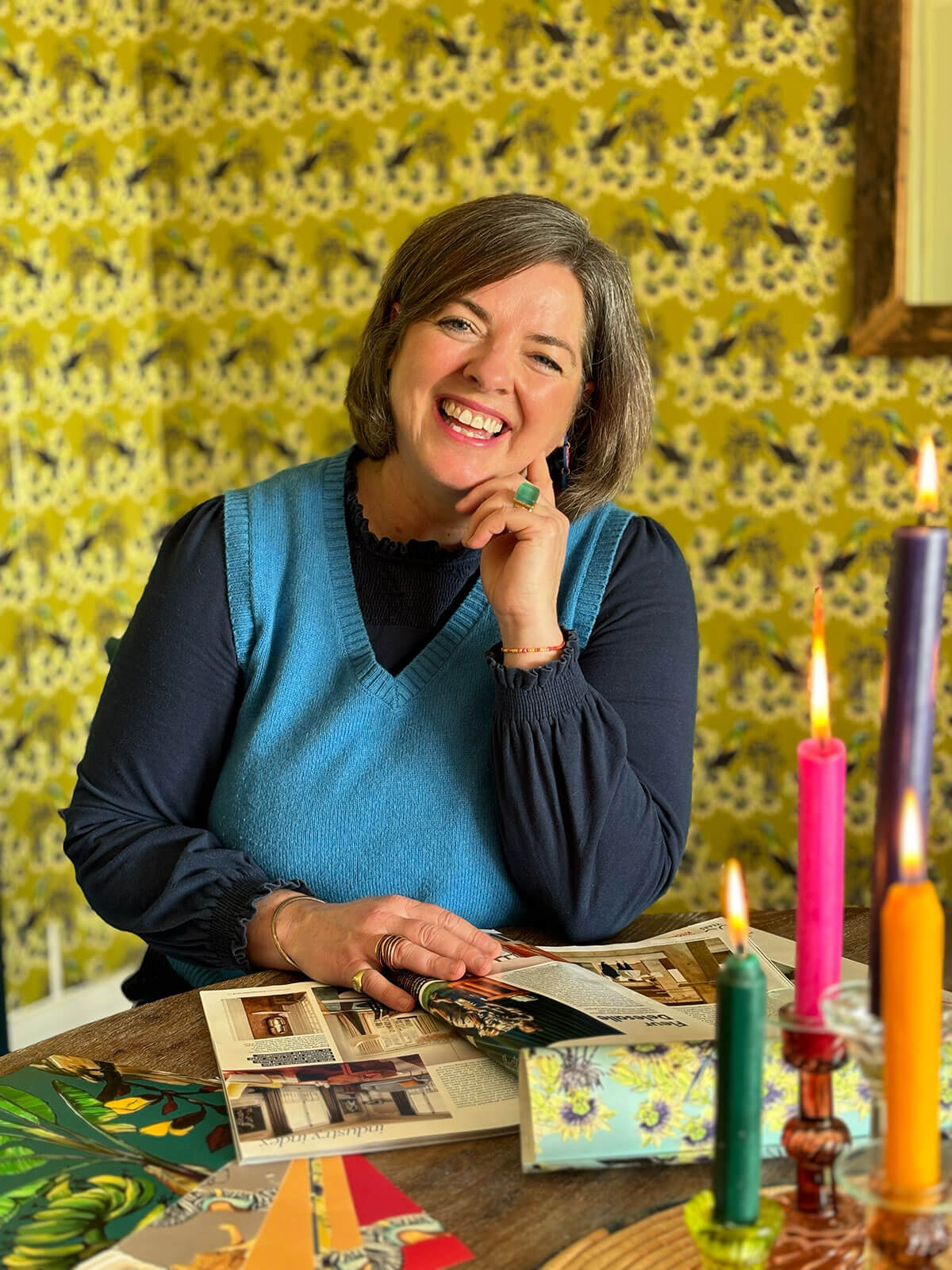 Example of DIY personal branding photography showing a creative business owner surrounded by her work tools and materials in her home workspace